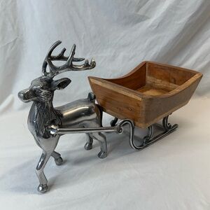 Christmas metal reindeer pulling a wooden sleigh